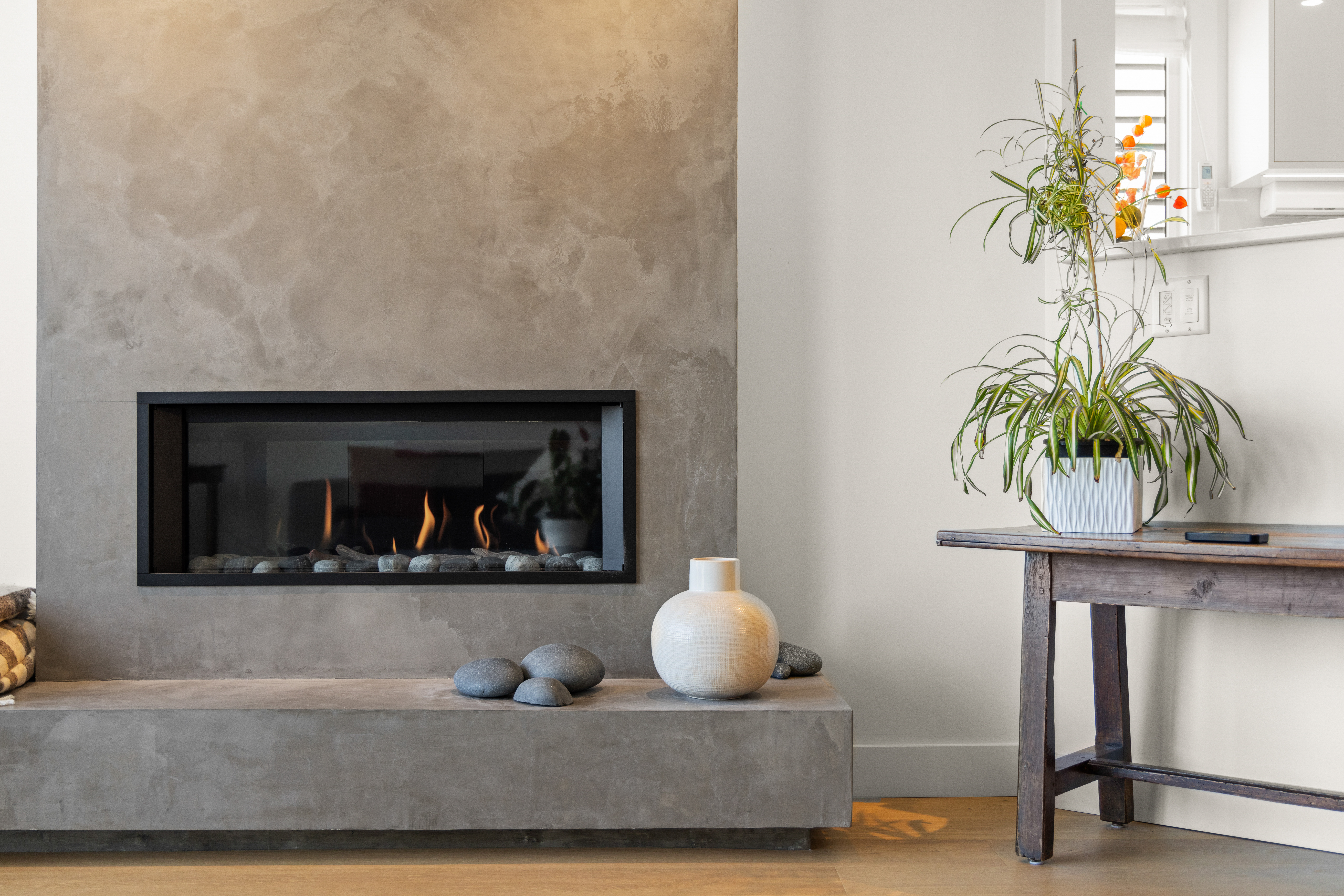 Staged living room with concrete fireplace